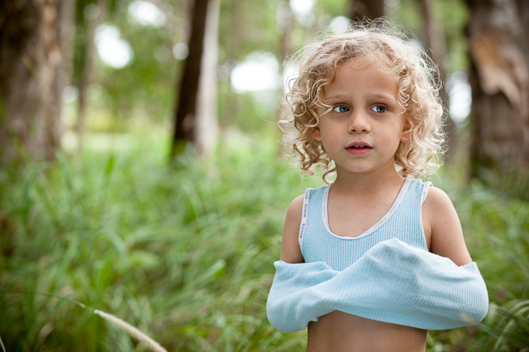 Family photography in Centennial Park, Sydney. Boy surrounded by nature.