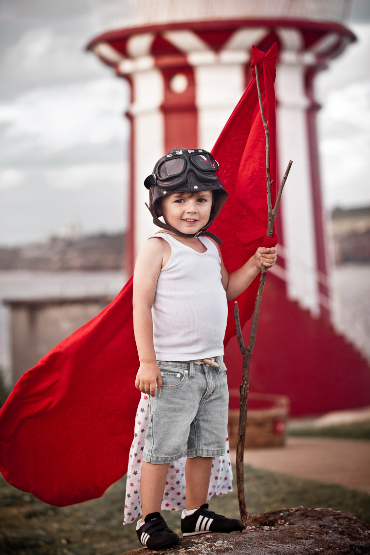 Boy at lighthouse, styled shoot with red and white theme.