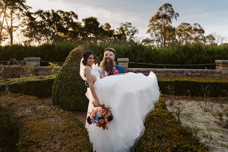 Groom carries bride.