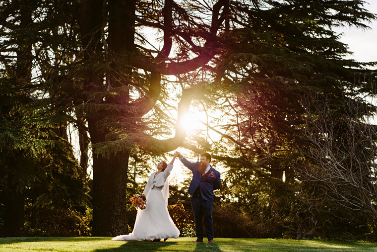 Bride and groom dance in the garden.