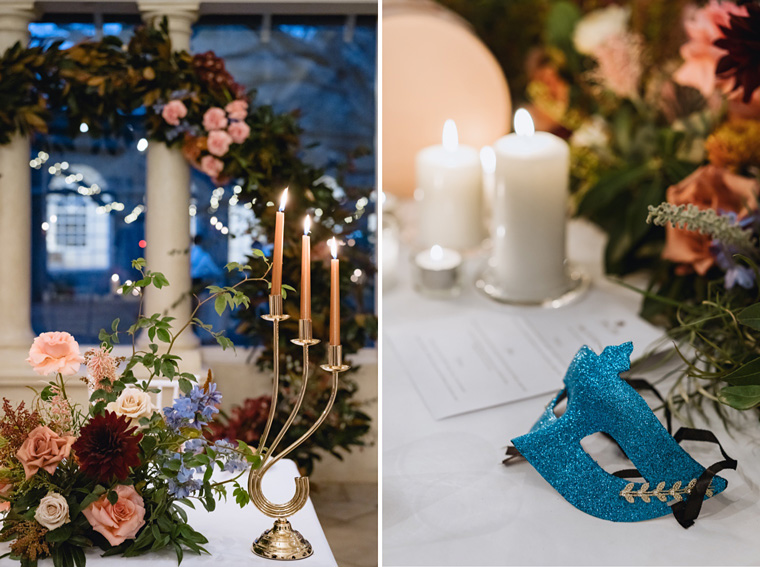 Wedding cake on a table with floral archway behind.