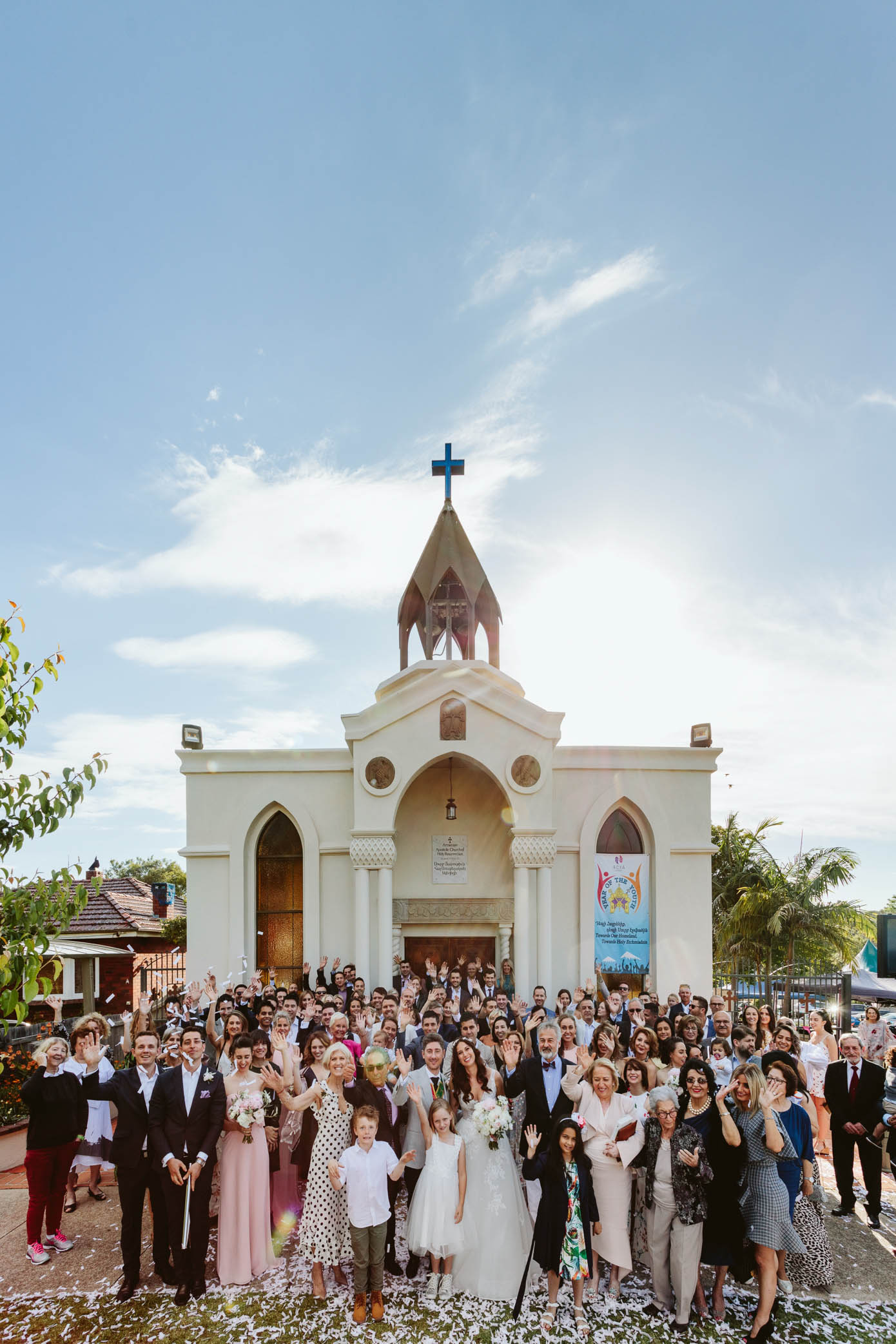 The church stands tall against a blue sky, marking the beginning of the couple’s new journey together.