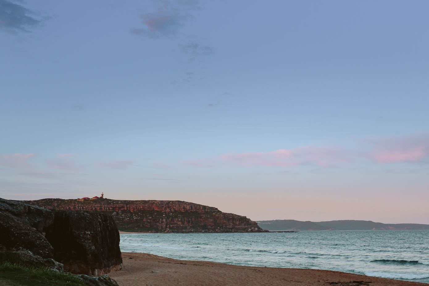 A scenic coastal view at sunset, capturing the beauty of the couple’s reception location.